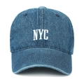 Close-up of NYC white embroidery and distressed denim texture on the baseball cap - Dark Blue