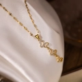 Elegant gold-plated heart necklace set with clear zircon stones on silk background - Gold Heart Style (24140)