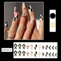 Detail of Halloween almond nails featuring ghosts, pumpkins and wizard hat patterns - BKSW532 Checkerboard Pumpkin