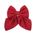 Detailed view of red floral pattern texture on a large fabric bow hair clip accessory - Red