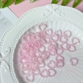 Pink heart-shaped faux pearl beads for DIY craft decoration on embossed white plate - Light Pink