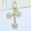 Light green floral metal keychain with three flower pendants and gold-finish hardware - Light Green