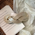 Detail of a beige twisted acetate hair clip with France Handmade text on neutral paper - 3# Milk White