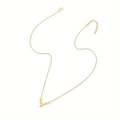 Detail of gold letter A pendant necklace with polished beads and lobster clasp closure - Letter A