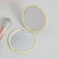 Foldable beige round compact makeup mirror with double-sided design for portability - Yellow