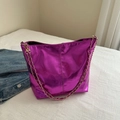 Metallic rose red bucket bag with a golden chain strap on a white textured surface - Purple