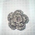 Detailed top view of a 7cm grey three-layer handmade crochet yarn flower on a cutting mat - 7cm / Iceland Yarn Grey