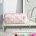 Close-up of pink quilted pencil case with bow pattern on desk with stationery - White with Pink Bow