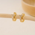 Macro view of gold chain-textured huggie earrings with T-shaped cubic zirconia detail - EH411022