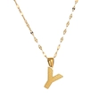 Close-up of golden letter Y pendant with honeycomb texture and fine chain necklace - Letter Y
