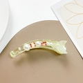 Detail of banana hair clip with white pearls and champagne square gems in a fish tail design - Green