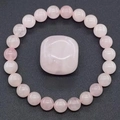 Natural pink crystal beaded bracelet featuring a polished rose quartz center stone - Rose Quartz