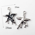 Macro view of silver alloy star pendant with black enamel finish showing 28mm size detail - Star Pendant