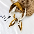 Pleated silk scarf with ginger yellow and coffee geometric stripes tied in a bow - Geometric Patchwork Yellow Brown