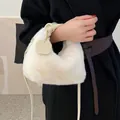 Creamy white plush crossbody bag with a knot handle and decorative tag detail - White