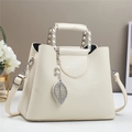 Beige lychee textured crossbody bag with silver leaf charm and pearl details - White