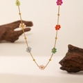Detailed macro view of colorful floral beaded necklace with gold stainless steel chain - Colorful Beaded Flower Necklace - Gold