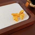 Detailed view of an oval gold butterfly ring with matte finish on a beige jewelry pad - Bow Frosted Style (5#) / Gold