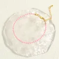 Detail shot of macaron pink beads and golden lobster clasp on Bohemian stretch bracelet - Pink