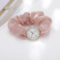 Detailed view of women's quartz watch with pink silk ribbon strap and daisy dial motif - Pink