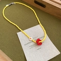 Detail shot of yellow beaded flower pendant necklace with high quality metal lobster clasp - Red Flower Yellow Beaded