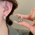 Close-up of elegant twisted silver hoop earrings worn to show detailed texture and size - 36# Ear Buckle - Silver Twisted Shape