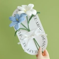 Handmade crochet bouquet with white and blue lily flowers on a white gift card - Blooming Tulip (Light Blue + White)