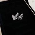 Macro shot of a silver butterfly earring featuring paved crystals and hollow metal patterns - Silver Butterfly Ear Cuff (Single)