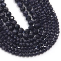 Macro detail of faceted blue sandstone beads with shimmering star-like inclusions for DIY jewelry - Blue Goldstone