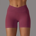 Close-up of high-waist yoga shorts with a cross waist design and ribbed texture fabric - S / Bottoms / Burgundy