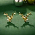 Golden reindeer stud earrings with sparkling zircon on a festive dark green backdrop - Gold