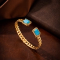 Detailed view of golden cubic chain bracelet featuring blue stones and zircon accents - 10111-Blue Bangle