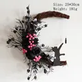 Detail of moon-shaped Halloween cat wreath with black roses and crystal pendant - Black Branch Pomegranate Cat