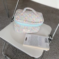 Quilted floral makeup bag in blue plaid with flowers on a minimal white chair - Green Plaid Floral