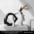 Abstract ceramic face silhouette vases in black and white with pink tulips - A Vase Of Two Flowers In Black And White With Tulips In Deep Pink (3 Pieces)