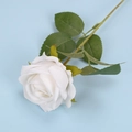 Single white artificial velvet rose with green leaves on light blue background - White