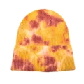 Detailed close-up of warm-toned tie-dye knit beanie with thick fold-over cuff design - Rust Yellow