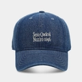Detailed close-up of dark blue denim baseball cap featuring white Sezo embroidered lettering - Dark Blue