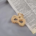 Detailed close-up of golden metal bow hair claw with woven texture and vintage finish - Gold Bowknot Textured