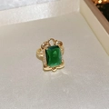Macro detail of emerald-cut green gemstone ring with gold plating and zircon accents - Style 5 Gold (Emerald Cut Green Gemstone)