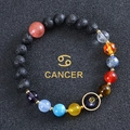 Detailed close-up of Cancer zodiac bracelet with black lava stone and colorful planet beads - Cancer