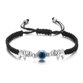 Detail of hand-woven black cord bracelet featuring blue evil eye and silver elephants - Elephant / Black