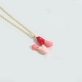 Gold-plated enamel bowling pin pendant necklace with red and pink charms on O-chain - Letter N