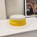 Close-up of woven straw texture and yellow fabric ribbon on white boater sun hat - White/Yellow Ribbon