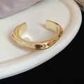 Macro shot of irregular wave-patterned gold cuff bracelet with high-polished texture - Gold Narrow Square