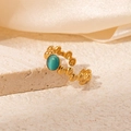 Close-up of gold plated ring with turquoise stone on beige textured stone and silk - Light Green Stone Style (R0813)