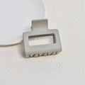 Detail of matte beige square claw clip on a white ceramic plate with a minimalist design - Matte Grey Beige Small Square Claw Clip (10#)