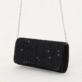 Close-up of black glitter evening bag with ruched texture and silver chain strap - Black