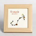 Square wooden frame featuring Scorpio zodiac design with crystal stones on light background - Scorpio