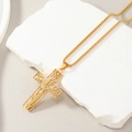 Macro detail of the golden cross pendant featuring a hollow tree pattern on stone base - Cross